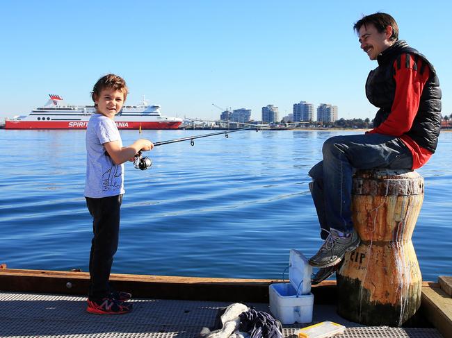17/05/20 Mike Burston fishing with his son Will down at Port Melbourne as COVID-19 restrictions ease around Australia. Aaron Francis/The Australian