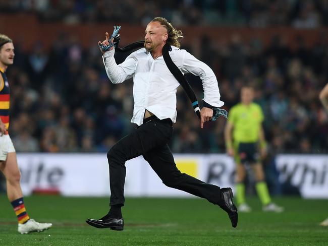 ADELAIDE, AUSTRALIA - AUGUST 20: Pitch invader  during the round 23 AFL match between the Port Adelaide Power and the Adelaide Crows at Adelaide Oval on August 20, 2022 in Adelaide, Australia. (Photo by Mark Brake/Getty Images)