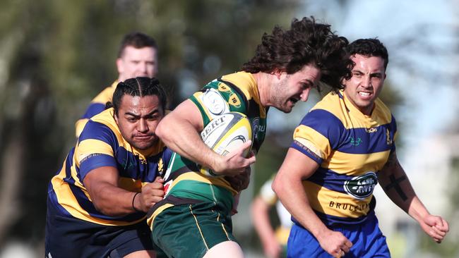 Surfers Paradise centre Joel Lonsdale runs at the Eagles defence during their rugby union match at James Overell Park, Southport. Photograph : Jason O'Brien