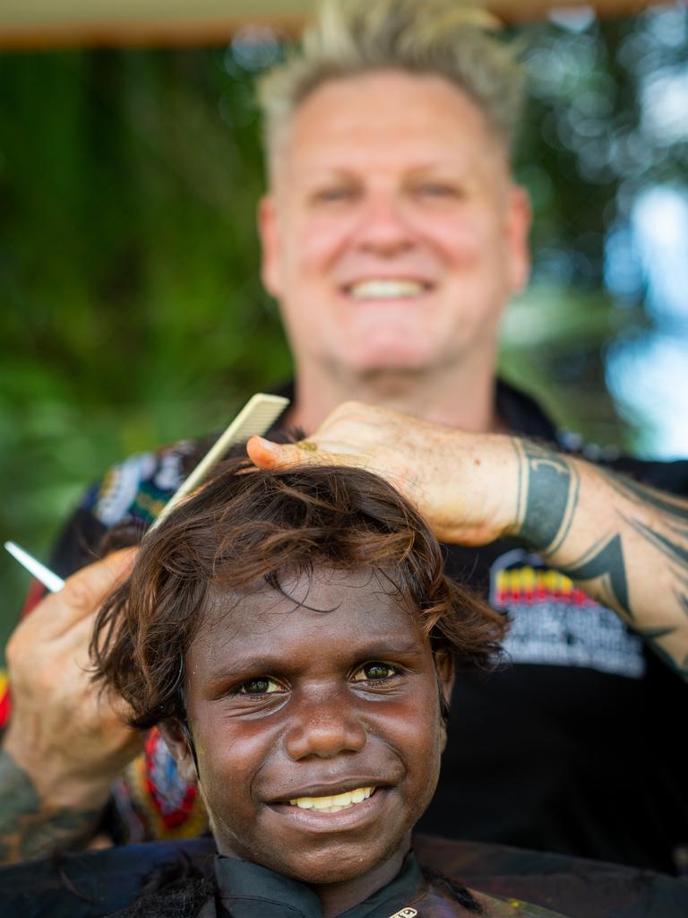 The Tiwi Islands 2020-2021 Grand Final. The Imalu Tigers take on the Walama Bulldogs on Bathurst Island. Gary Strachan, the 'Deadly Hair Dude', gives out haircuts to local kids for the game. Photograph: Che Chorley