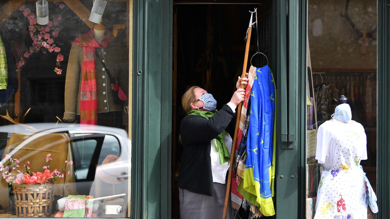 This woman was seen opening her shop in Salzburg after the Easter break. Picture: BARBARA GINDL/APA/ AFP