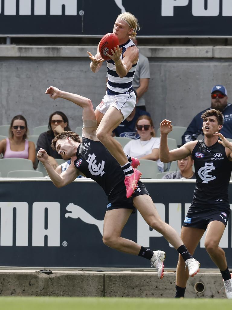 Oliver Dempsey of the Cats takes a hanger over Carlton’s Blake Acres. Picture: Michael Klein