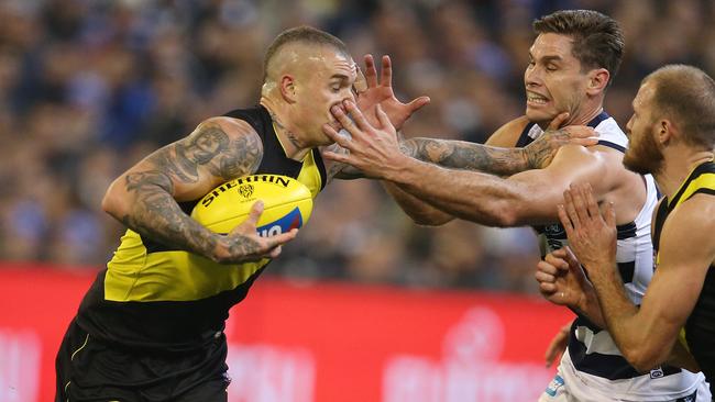 Dustin Martin fends off Geelong forward Tom Hawkins. Picture: Michael Klein.