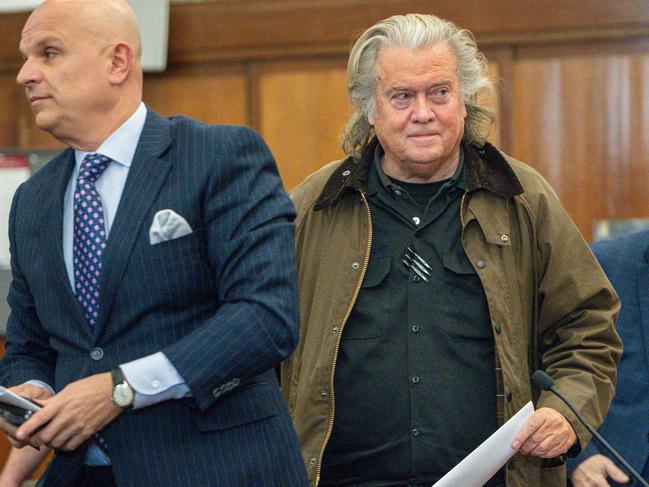 Steve Bannon(C), former advisor to US President Donald Trump, and his lawyer Arthur Aidala (L) arrive for a pre-trial conference hearing where he entered a guilty plea in his fraud case stemming from a fundraising effort to build a border wall, at New York Criminal Court in Manhattan on February 11, 2025. Bannon, 71, entered a guilty plea to New York state charges as part of an agreement that spared him prison time. (Photo by Steven HIRSCH / POOL / AFP)