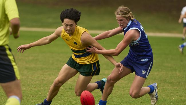 Pembroke’s William Watts and Sacred Heart’s Bowen Payne in action in their college footy clash on Saturday. Picture: Matt Loxton