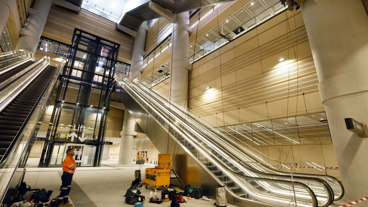 Workers doing last minute work at the entrance to the brand new Martin Place Metro Station in Sydney. Picture: Richard Dobson