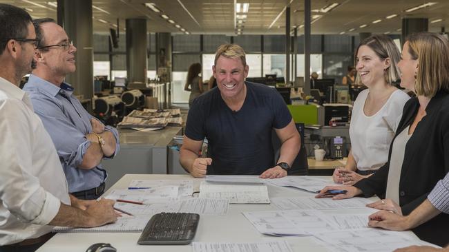 Guest Editor of the Advertiser Shane Warne holds the morning conference with, from left, Brad Fleet, Matt Deighton, Shane Warne, Jess Leo-Kelton and Kara Jung. Picture: Simon Cross