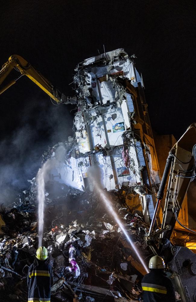 Firefighters spray the water on a collapsed building following an earthquake in Hualien, Taiwan. Picture: Getty Images