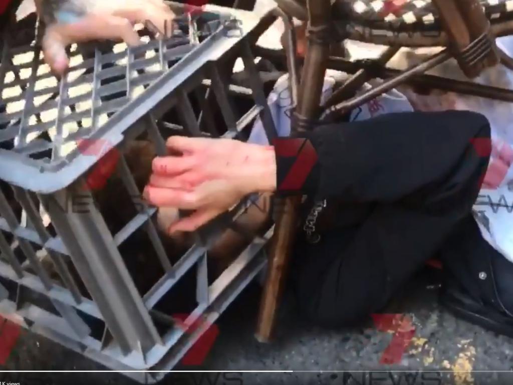 The man was restrained by members of the public with a milk crate and chairs. Picture: Channel 7