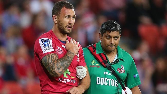 Quade Cooper is helped off the field after injuring his shoulder.