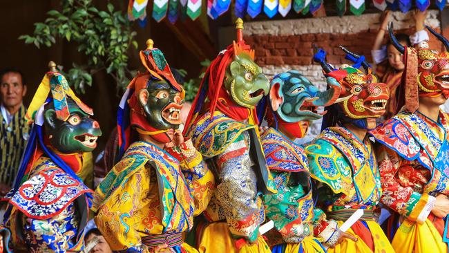 Mask dancers at the annual Paro Tshechu (religious festival) at Paro's Rinpung Dzong (a Buddhist monastery and fortress).