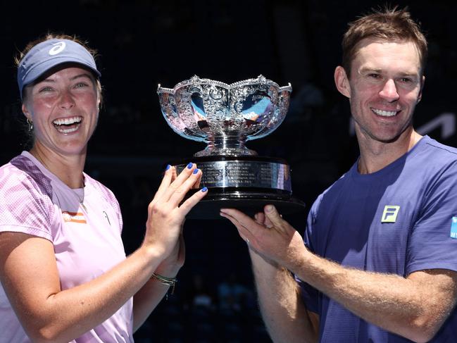 Australia's Olivia Gadecki (L) and John Peers celebrate with the trophy after their victory against Australia's Kimberly Birrell and John-Patrick Smith in their mixed doubles final match on day thirteen of the Australian Open tennis tournament in Melbourne on January 24, 2025. (Photo by David GRAY / AFP)