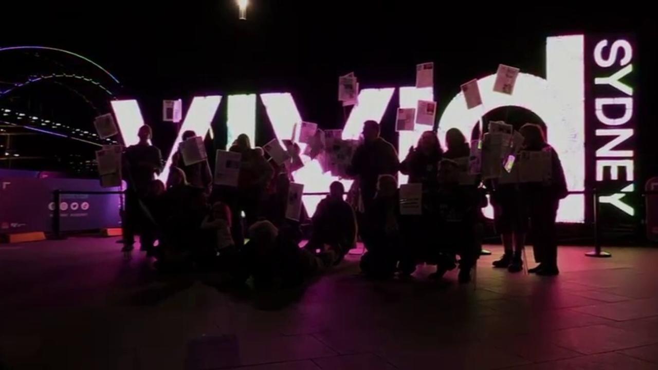 The group posed in front of an illuminated ‘Vivid Sydney’ sign. Picture: Facebook