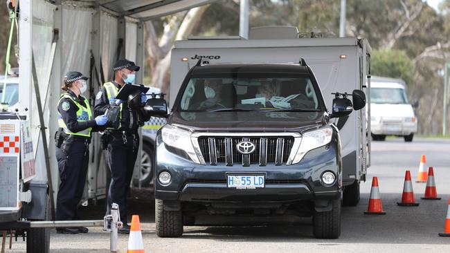 Police check a car towing a caravan on the SA border in July. Picture: Tait Schmaal