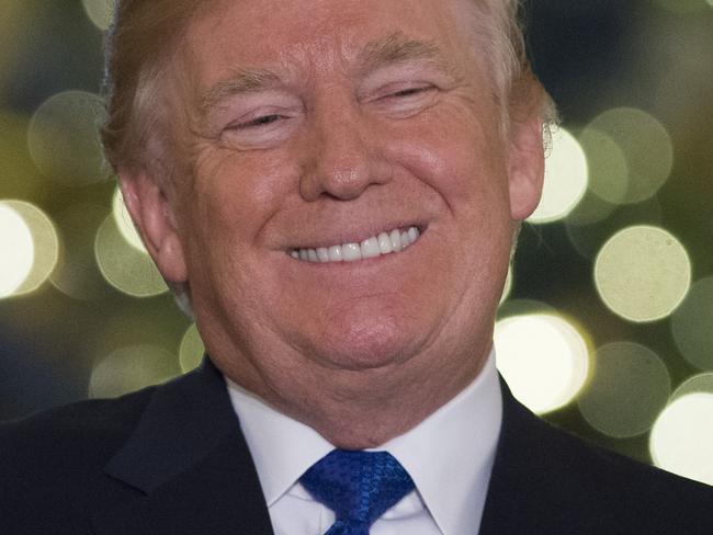 US President Donald Trump speaks about the tax reform legislation in the Grand Foyer of the White House in Washington, DC, December 13, 2017. / AFP PHOTO / SAUL LOEB