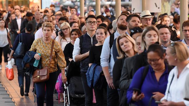 Frustrated commuters wait patiently near the Arts Centre. Picture: Lawrence Pinder