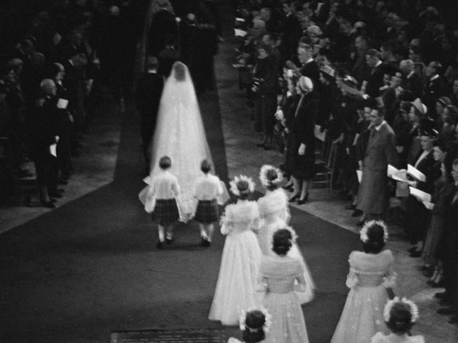 Princess Elizabeth (later Queen Elizabeth II) and Prince Philip make their way down the aisle of Westminster Abbey. Picture: Getty