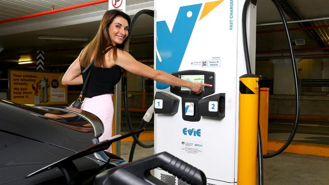 EV driver Michelle Ryan, Director of Bespoke Money Mortgage Broking, charging her vehicle at the Evie Network Charging station inside Indooroopilly shopping centre. Picture: David Clark