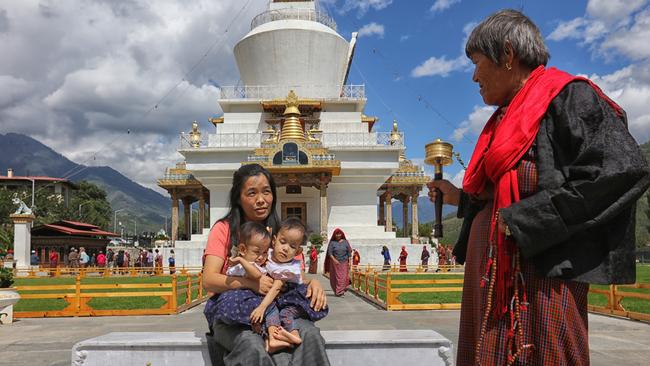 Mum Bhumchu Zangmo with Nima and Dawa visiting a Buddhist Temple in Thimphu, Bhutan. Picture: Alex Coppel