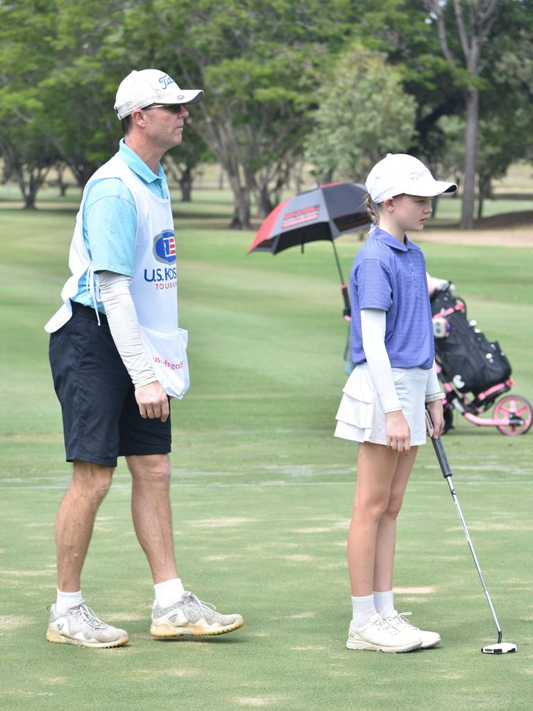 Brisbane's Zoe Weatherhead (girls 11-12 years) discusses the line of her putt with Richard Weatherhead at the US Kids Golf Foundation Australian Open at the Rockhampton Golf Club on September 28.