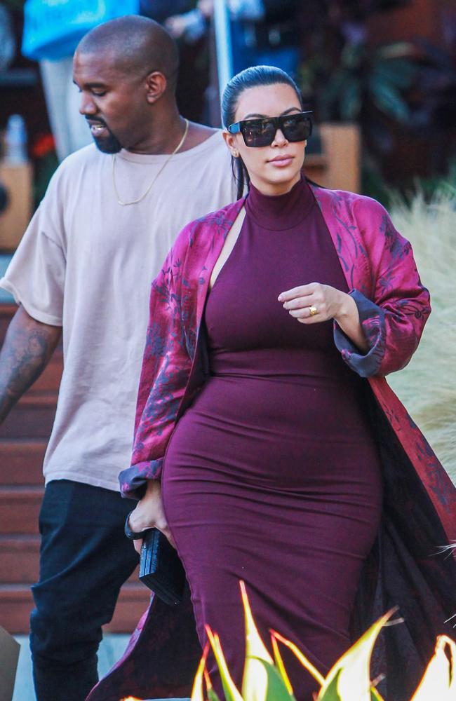 Kim showed off her growing baby bump in a tight maroon dress on a dinner date at Nobu Restuarant in Malibu on July 11, 2015. Picture: Splash