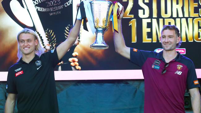 Captains Darcy Moore and Harris Andrews show off the premiership trophy to adoring fans. Picture: NCA NewsWire / David Crosling