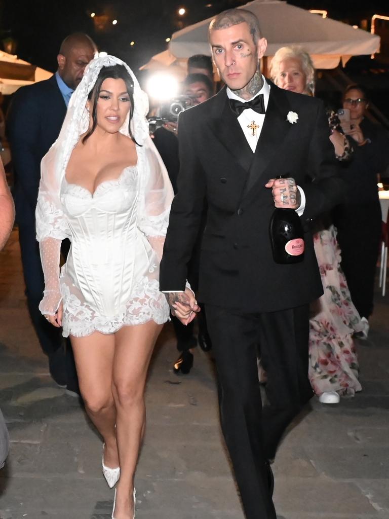 The bride wore a Dolce and Gabbana minidress, while the groom was in a suit by the same designer. Picture: Cobra Team/Backgrid