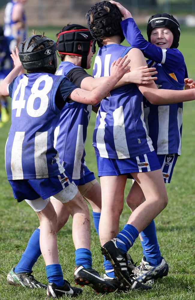 Jack’s teammates rally around him to celebrate his 100th goal. Picture: Norm Oorloff