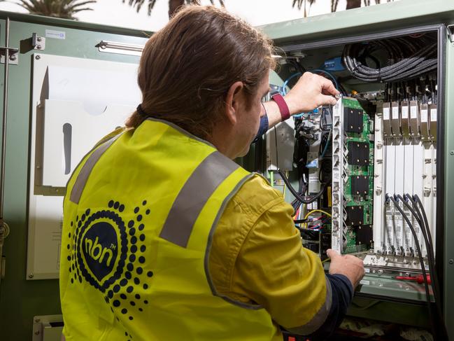 An NBN Co. technician handles hardware in a fiber distribution cabinet during the installation of fiber-to-the-building connections in Sydney, Australia, on Tuesday, Oct. 3, 2017. NBN says it's aiming to increase annual revenue more than five-fold to A$5.4 billion and be cash flow positive in 2021. Photographer: Cole Bennetts/Bloomberg via Getty Images