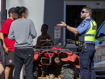 Police talk to youth on a quadbike at a serviec station in downtown Carnarvon. Picture: Jon Gellweiler/news.com.au