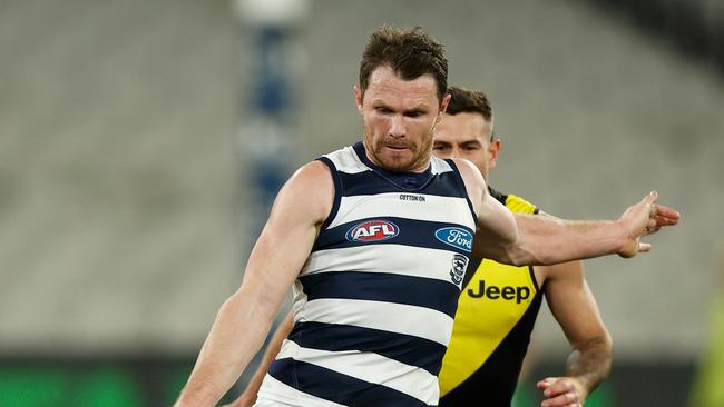 MELBOURNE, AUSTRALIA – JULY 25: Patrick Dangerfield of the Cats kicks the ball during the 2021 AFL Round 19 match between the Geelong Cats and the Richmond Tigers at the Melbourne Cricket Ground on July 25, 2021 in Melbourne, Australia. (Photo by Michael Willson/AFL Photos via Getty Images)