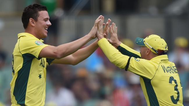 Josh Hazlewood celebrates with David Warner.