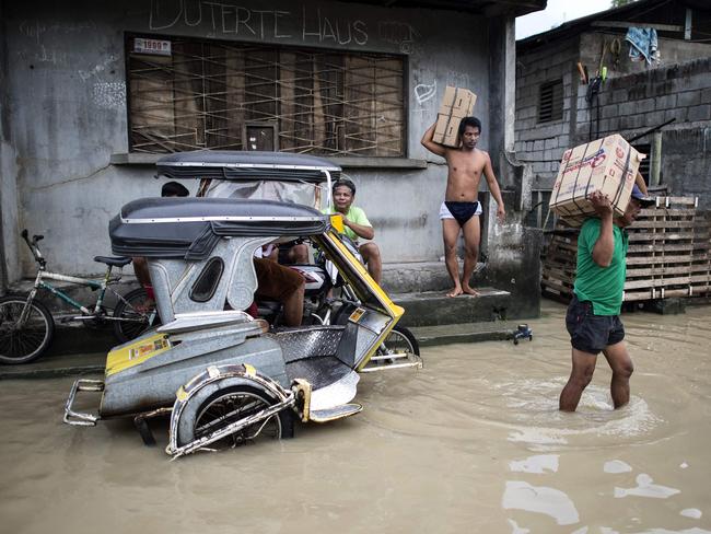 Residents wade through a flooded street in the aftermath of Super Typhoon Mangkhut in Calumpit, Bulacan — Philippines. Picture: AFP