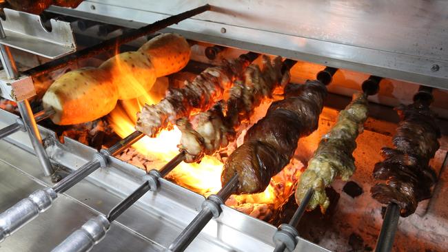 Skewered meat cooking at Navala Churrascaria in Brisbane City.