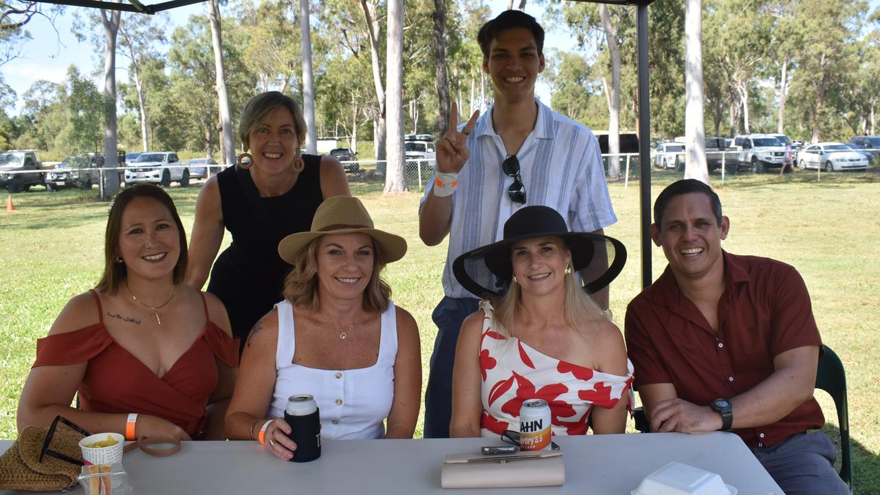 Leanne Edmistone and Dylan Hughes (back) with Kathryn Mitriaev, Melanie Gibbards and Kristie and Julius Hughes at the Yeppoon race day at Keppel Park racecourse on April 26, 2025.