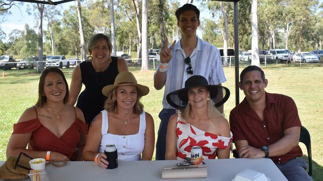 Leanne Edmistone and Dylan Hughes (back) with Kathryn Mitriaev, Melanie Gibbards and Kristie and Julius Hughes at the Yeppoon race day at Keppel Park racecourse on April 26, 2025.