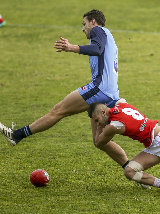 Come here. North’s Robbie Young tackles Fraser Evans. Picture: Mile Burton/AAP