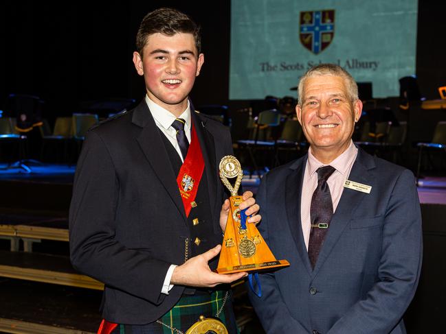 Dylan, pictured with principal Mark Geraets, won the Clan Lamont Piping Award.