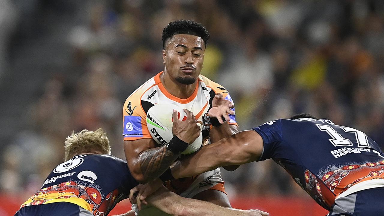 TOWNSVILLE, AUSTRALIA - MAY 24: Fonua Pole of the Tigers is tackled during the round 12 NRL match between North Queensland Cowboys and Wests Tigers at Qld Country Bank Stadium, on May 24, 2024, in Townsville, Australia. (Photo by Ian Hitchcock/Getty Images)