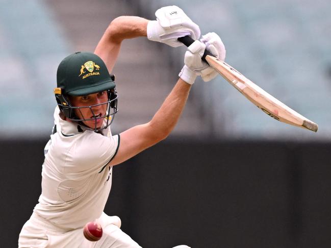 Australian batsman Nathan McSweeney plays a shot on the third day of the Australia A against India A cricket match at the Melbourne Cricket Ground (MCG) in Melbourne on November 9, 2024. (Photo by William WEST / AFP) / --IMAGE RESTRICTED TO EDITORIAL USE - STRICTLY NO COMMERCIAL USE--