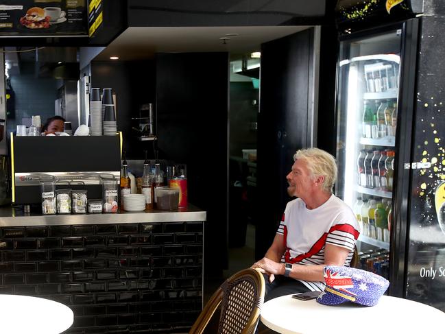 Sir Richard Branson enjoys a coffee after the ferry ride. Picture: Toby Zerna