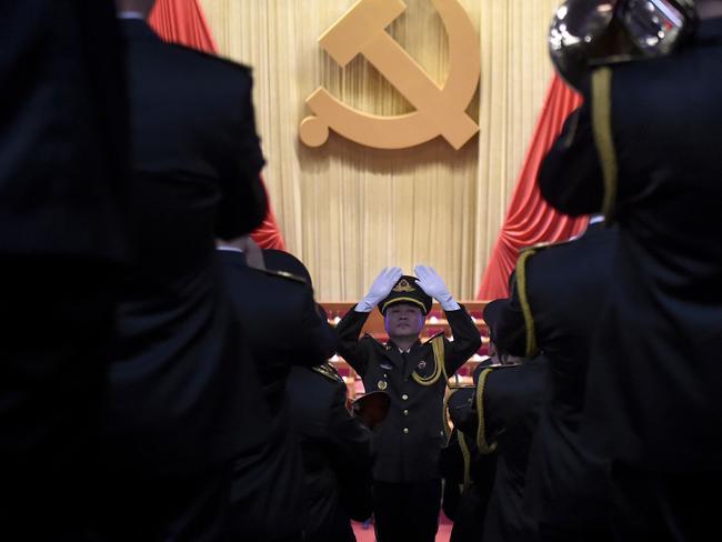 A Chinese People’s Liberation Army (PLA) officer practices conducting a military band before the opening session of the Chinese Communist Party’s five-yearly Congress. Picture: Wang Zhao/AFP