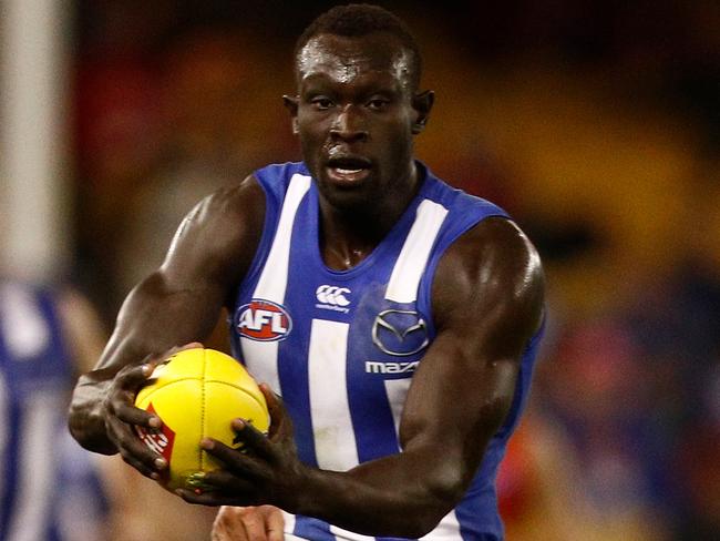 MELBOURNE, VICTORIA - JULY 08:  Majak Daw of the Kangaroos is tackled by Will Brodie of the Suns during the round 16 AFL match between the North Melbourne Kangaroos and the Gold Coast Titans at Etihad Stadium on July 8, 2018 in Melbourne, Australia.  (Photo by Daniel Pockett/AFL Media/Getty Images)