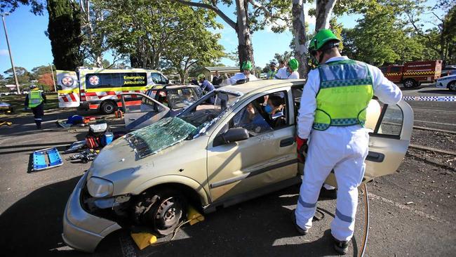 Tweed Volunteer Rescue Association president Drew Carr rescues patients in a mock emergency scenario for students at Murwillumbah. Picture: Scott Powick