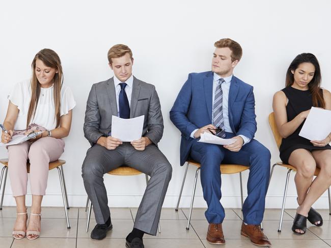 Candidates waiting for job interviews, full length, front. iStock