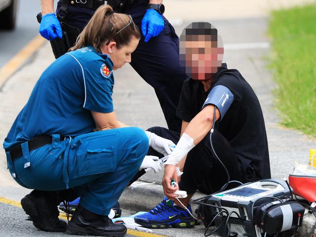 The teenager is treated by paramedics at the scene. Photo: Scott Powick.