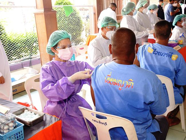 Health workers administering doses of vaccine for the Covid-19 coronavirus for inmates at Minburi Remand Prison in Bangkok. Picture: AFP PHOTO