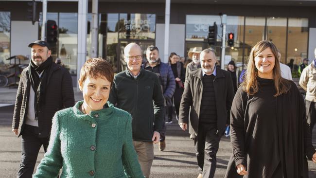 State roads minister Jaala Pulford (green jacket) and Helen Kratzmann step over the road. Picture: Angela Cornish