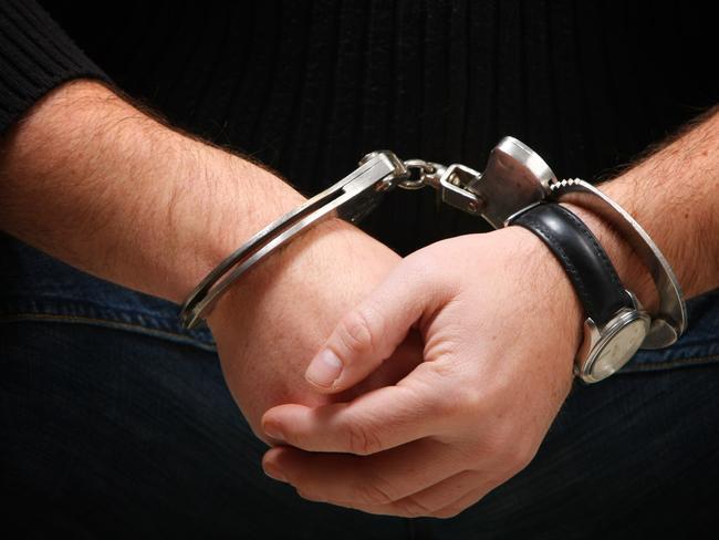 Busted - Man wearing handcuffs Source : Thinkstock