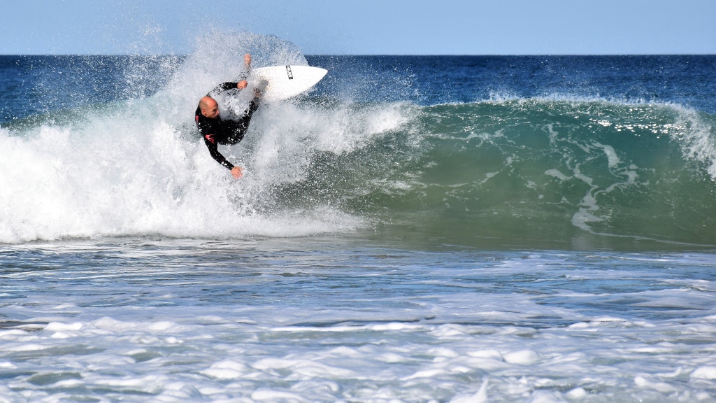 Surfers and bodyboard riders making the most of the waves at Kawana on the weekend. Picture: Mark Furler